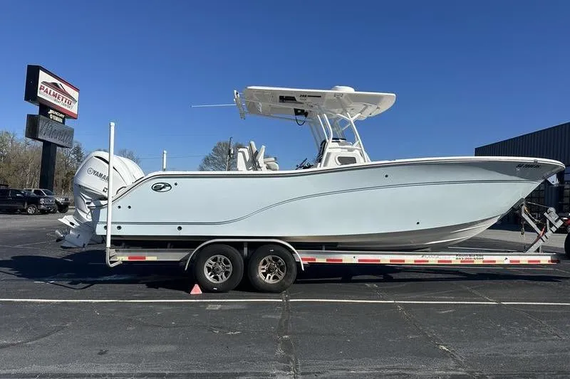 The Image of 2022 Sea Fox 288 Commander boat on trailer, parked outdoors under clear blue sky. - 1