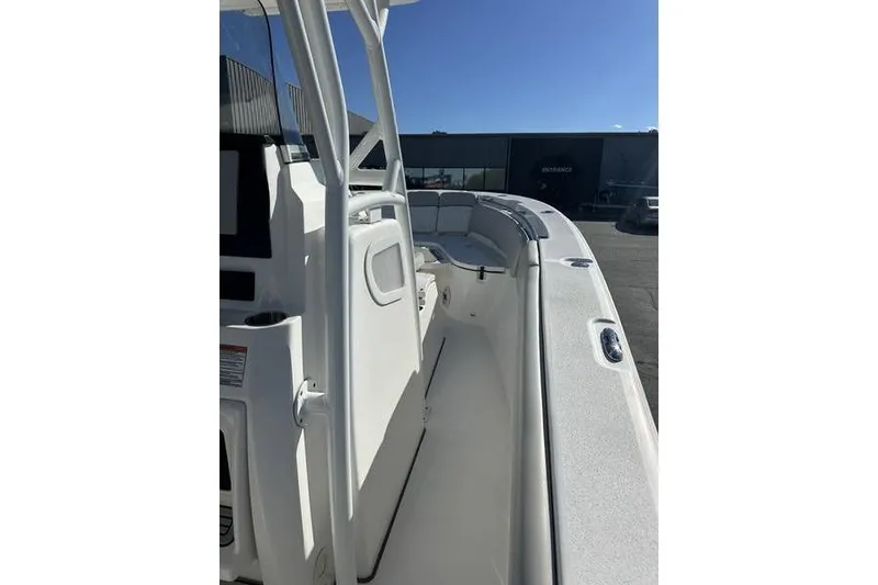 Slide: The Image of 2022 Sea Fox 288 Commander boat interior with seating and console, under clear blue sky. - 11