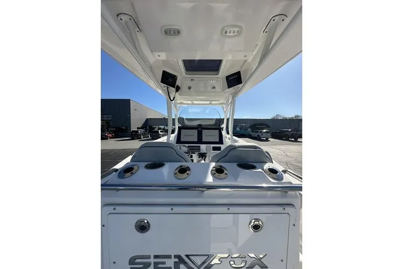 Slide: The Image of 2022 Sea Fox 288 Commander boat interior with dual screens and cup holders. - 4