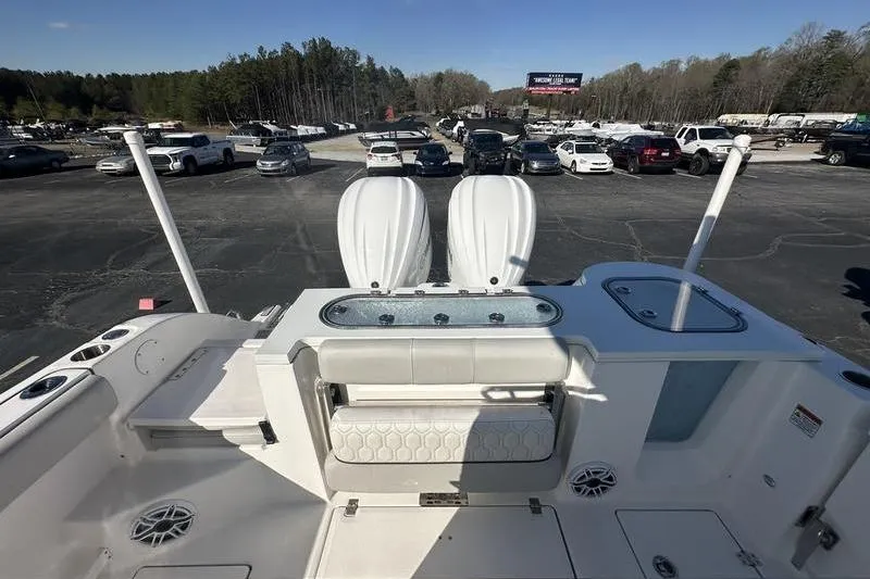 Slide: The Image of 2022 Sea Fox 288 Commander boat interior with seating and storage, parked in a lot. - 5