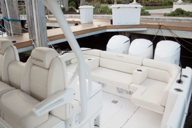 Slide: The Image of Luxury Everglades 360 LXC boat interior with plush seating, docked at marina. - 12