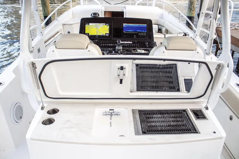 Slide: The Image of Cockpit of 2017 Everglades 360 LXC boat with navigation screens and controls. - 13