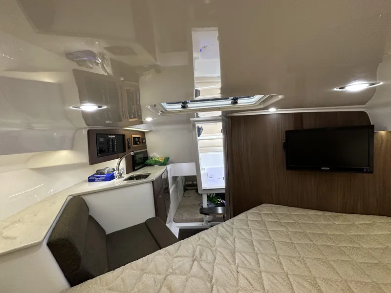 Slide: The Image of Interior of 2017 Everglades 360 LXC boat with kitchenette and TV. - 25