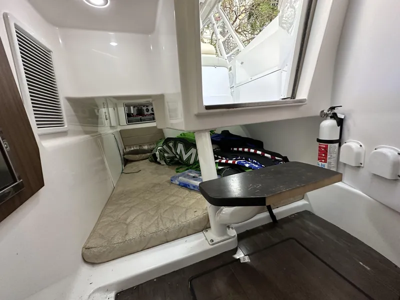 Slide: The Image of Interior cabin of 2017 Everglades 360 LXC boat with bed and fire extinguisher. - 26