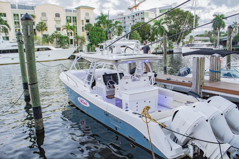 Slide: The Image of 2017 Everglades 360 LXC boat docked in a marina with scenic waterfront view. - 3
