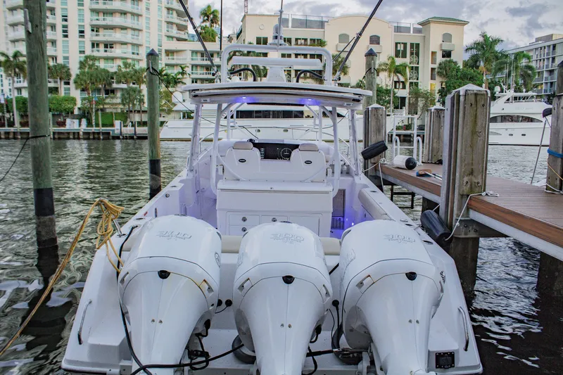 Slide: The Image of 2017 Everglades 360 LXC boat docked with triple outboard engines. - 4