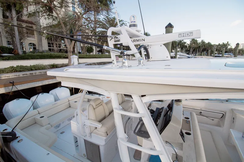 Slide: The Image of 2017 Everglades 360 LXC boat with Garmin radar, docked near palm trees. - 7