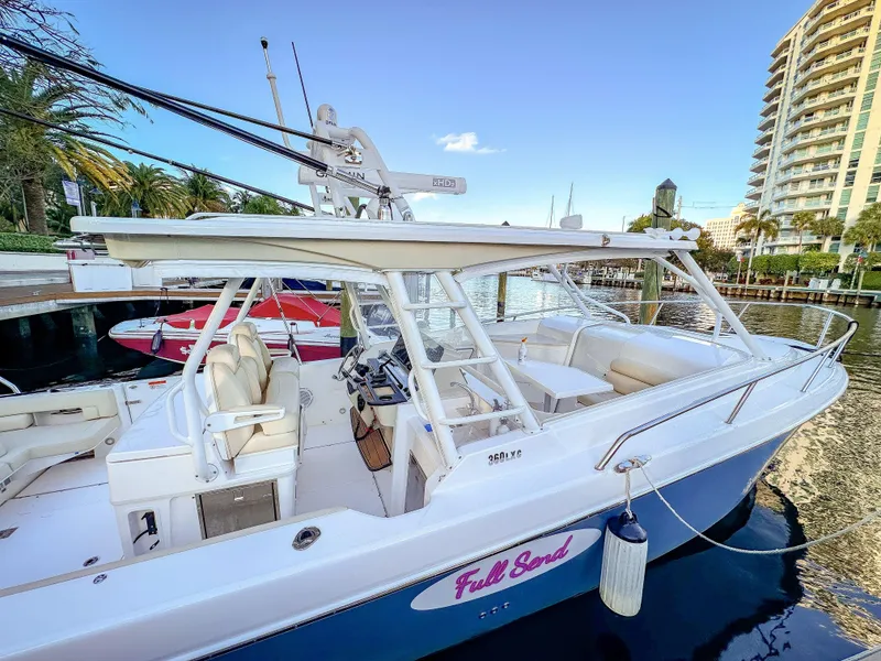 Slide: The Image of 2017 Everglades 360 LXC boat docked in marina, clear sky, luxury setting. - 9
