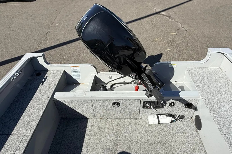 Slide: The Image of 2022 Smoker Craft Freedom 160 SC boat interior with motor and controls. - 10