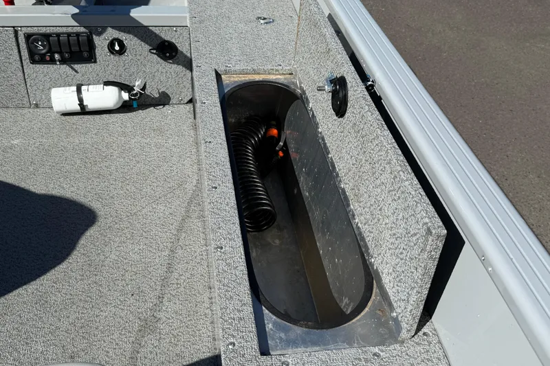 Slide: The Image of 2022 Smoker Craft Freedom 160 SC boat interior with storage compartment and fire extinguisher. - 12