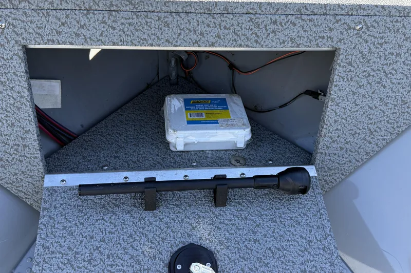 Slide: The Image of 2022 Smoker Craft Freedom 160 SC interior storage compartment with wiring and equipment. - 15