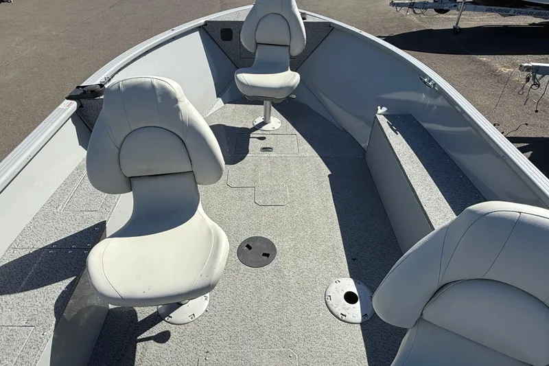 Slide: The Image of 2022 Smoker Craft Freedom 160 SC boat interior with white seating and spacious layout. - 6
