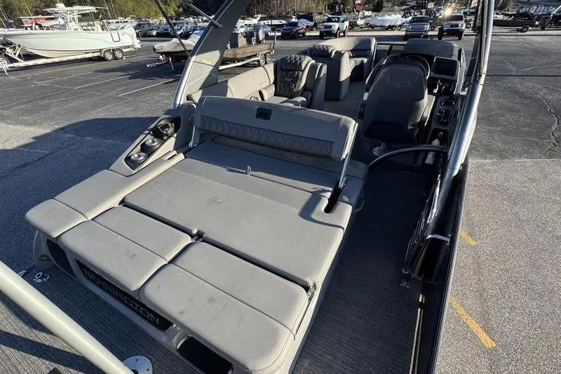 Slide: The Image of 2024 Bennington 25 QXSBA pontoon boat with spacious seating and modern design. - 13