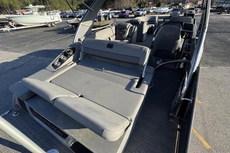Slide: The Image of 2024 Bennington 25 QXSBA pontoon boat with spacious seating and modern design. - 14