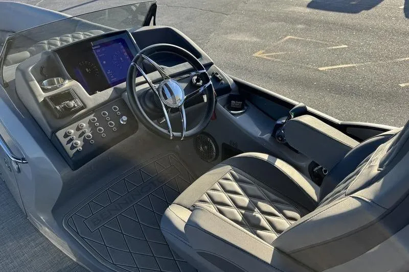 Slide: The Image of 2024 Bennington 25 QXSBA boat interior with steering wheel and control panel. - 16