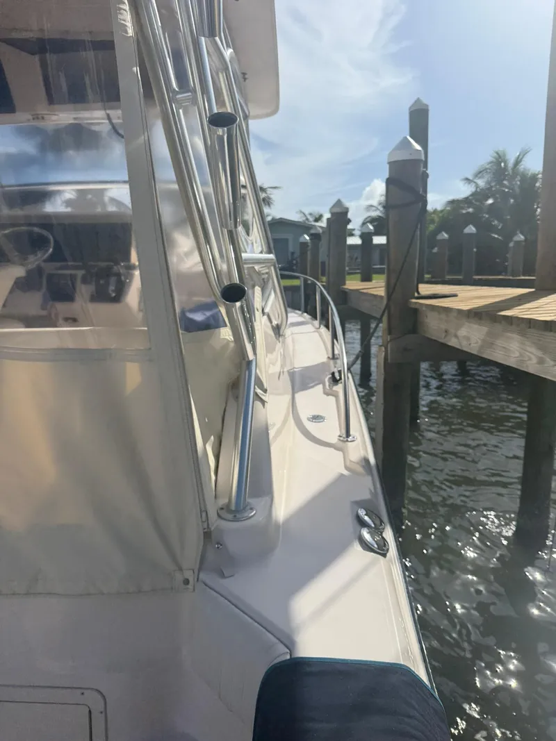 Slide: The Image of 2007 Grady-White Express 330 boat docked, featuring sleek design and sunny waterfront setting. - 21