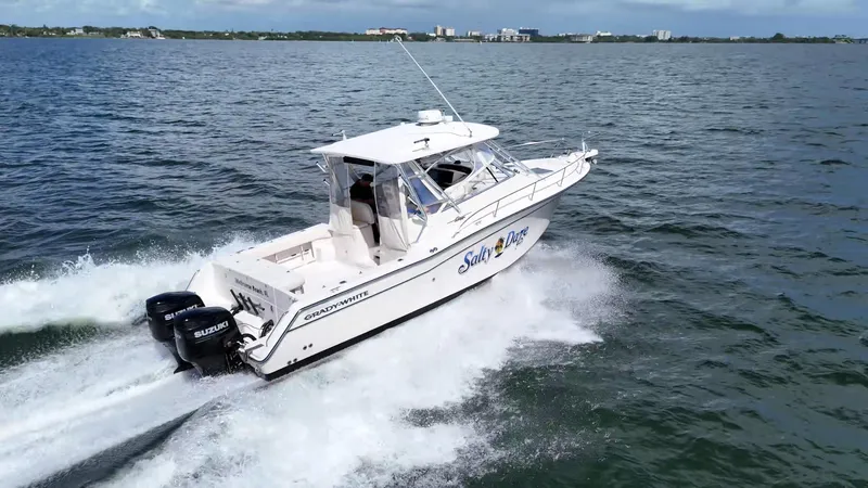 Slide: The Image of 2007 Grady-White Express 330 boat cruising on open water with dual Suzuki engines. - 3