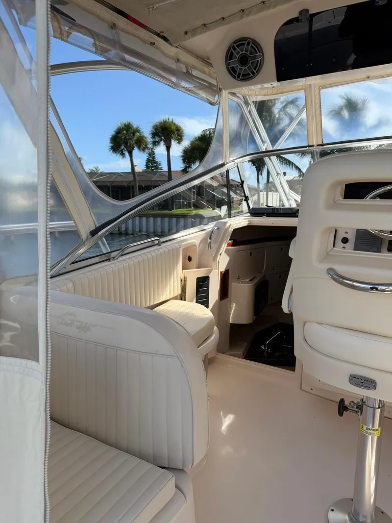 Slide: The Image of 2007 Grady-White Express 330 boat interior with white seating and clear windows. - 30