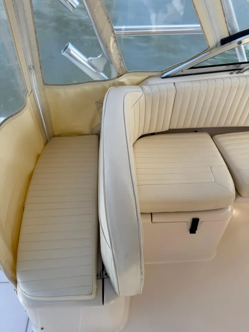 Slide: The Image of 2007 Grady-White Express 330 boat interior with cream-colored seating and clear windows. - 35