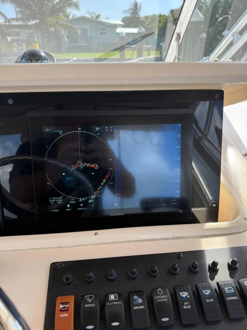 Slide: The Image of Control panel of a 2007 Grady-White Express 330 boat with Garmin navigation display. - 46