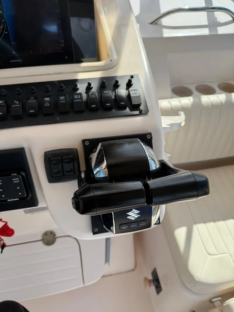 Slide: The Image of Control panel of a 2007 Grady-White Express 330 boat with Suzuki throttle. - 48