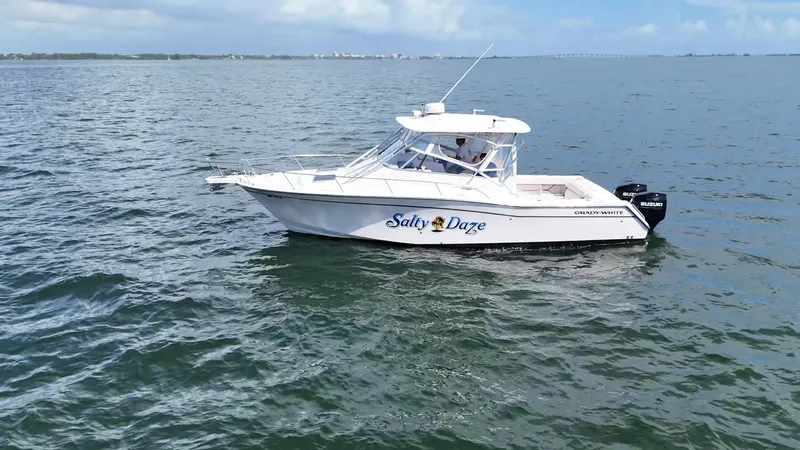 Slide: The Image of 2007 Grady-White Express 330 boat named "Salty Daze" cruising on open water. - 5