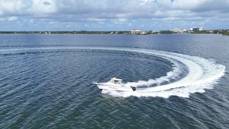 Slide: The Image of 2007 Grady-White Express 330 making a sharp turn on a calm lake. - 9