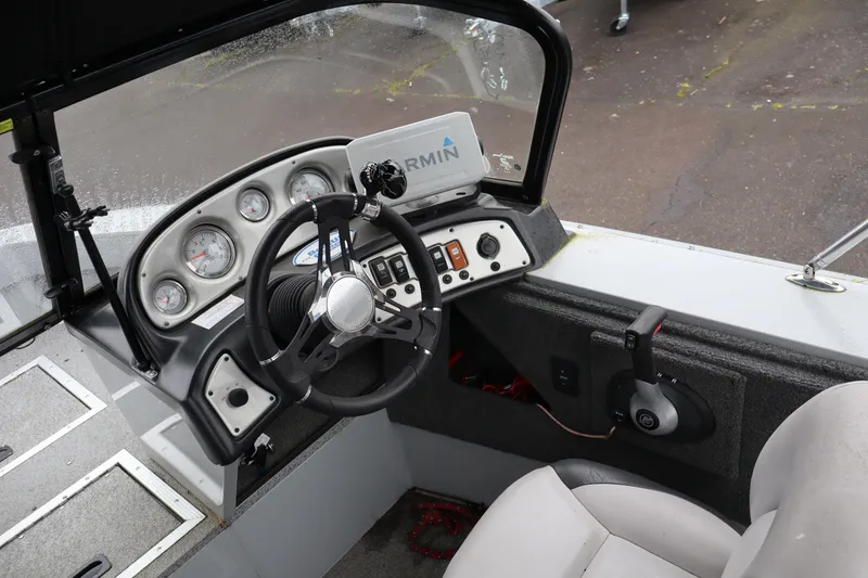 Slide: The Image of 2021 Smoker Craft Osprey 162 boat dashboard with steering wheel and Garmin navigation system. - 12