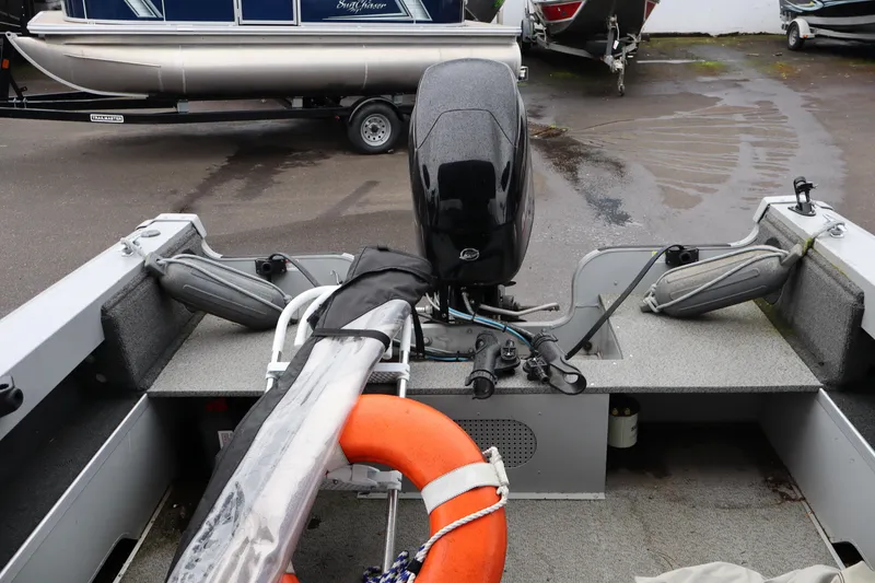 Slide: The Image of 2021 Smoker Craft Osprey 162 boat interior with motor and safety equipment. - 13