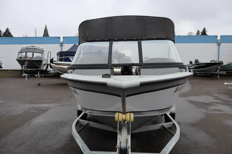 Slide: The Image of 2021 Smoker Craft Osprey 162 boat on trailer, parked outdoors on a cloudy day. - 3