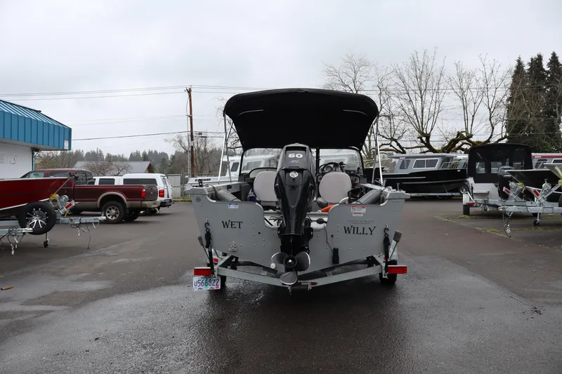 Slide: The Image of 2021 Smoker Craft Osprey 162 boat with outboard motor in a parking lot. - 4