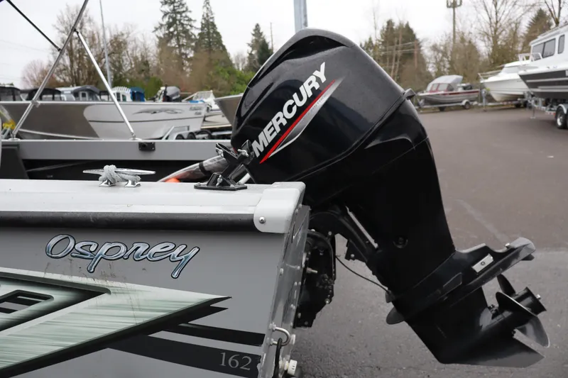 Slide: The Image of 2021 Smoker Craft Osprey 162 boat with Mercury outboard motor in a marina setting. - 5