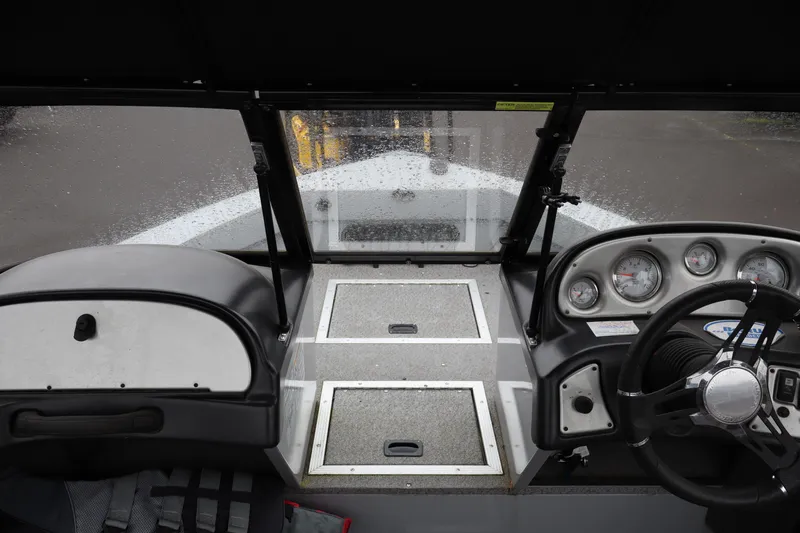 Slide: The Image of 2021 Smoker Craft Osprey 162 boat dashboard with gauges and steering wheel. - 9