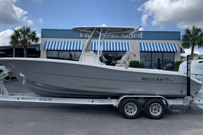 The Image of 2026 Bulls Bay 255 Center Console boat on trailer outside dealership. - 0