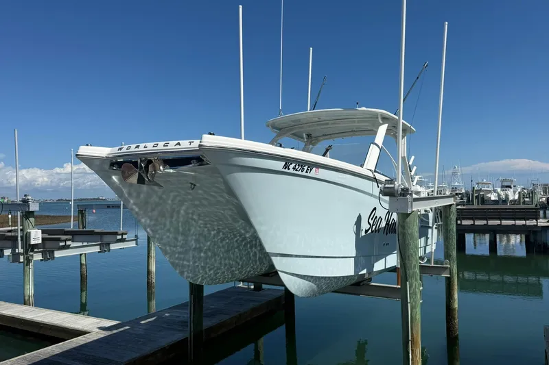 The Image of 2023 World Cat 280 DC-X boat docked at marina under clear blue sky. - 1