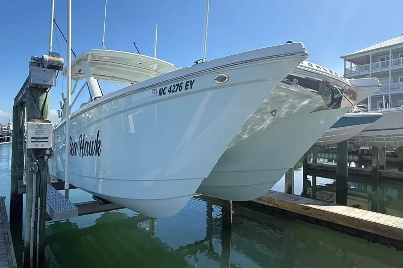 Slide: The Image of 2023 World Cat 280 DC-X boat docked, featuring sleek design and modern amenities. - 13