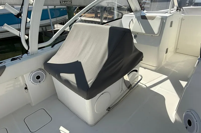 Slide: The Image of 2023 World Cat 280 DC-X boat interior with covered seating and marine speakers. - 5