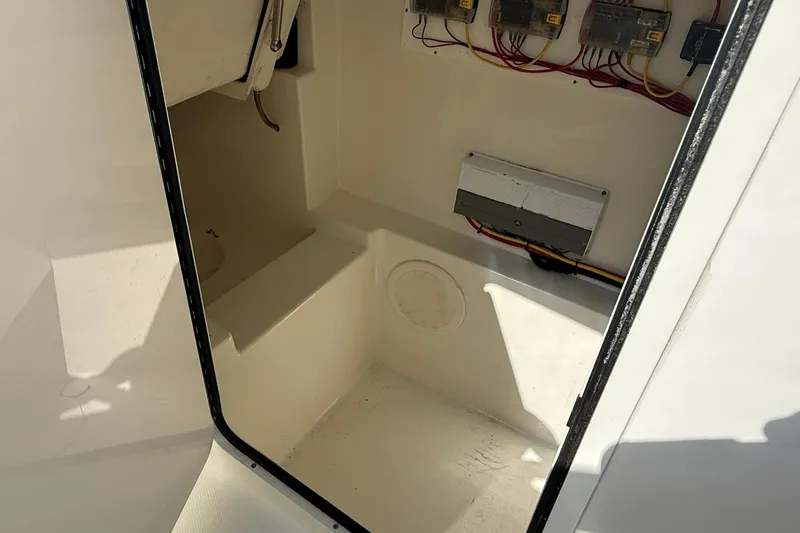 Slide: The Image of Interior view of 2023 World Cat 280 DC-X boat's storage compartment with wiring. - 7