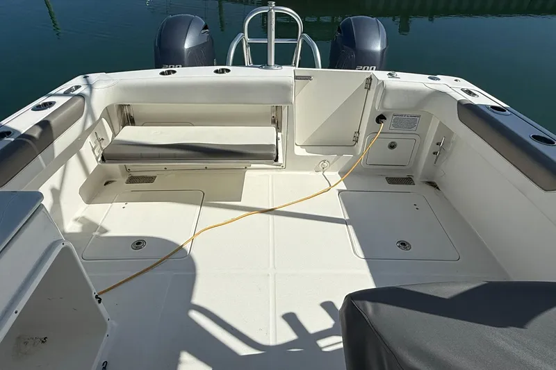 Slide: The Image of 2023 World Cat 280 DC-X boat deck with seating and storage compartments. - 9