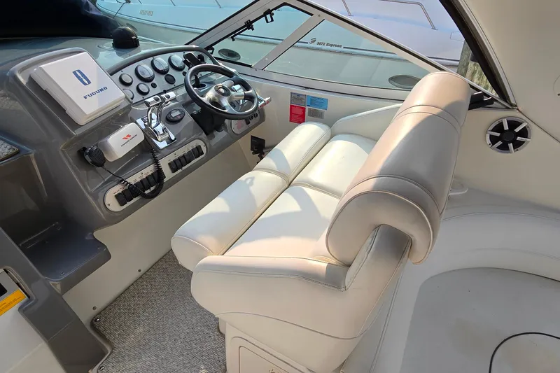 Slide: The Image of 2005 Cruisers Yachts 340 Express helm with steering wheel and control panel. - 10