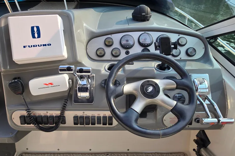 Slide: The Image of Control panel of 2005 Cruisers Yachts 340 Express with steering wheel and navigation equipment. - 11