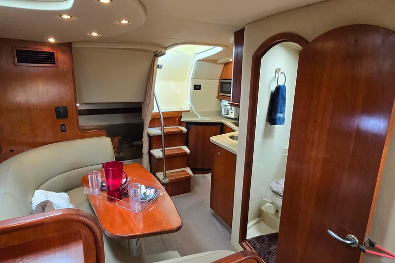 Slide: The Image of Luxurious 2005 Cruisers Yachts 340 Express cabin interior with kitchenette and seating area. - 16