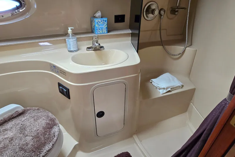 Slide: The Image of Bathroom interior of 2005 Cruisers Yachts 340 Express with sink, shower, and toilet. - 22
