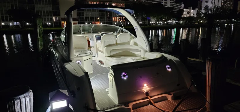 Slide: The Image of 2004 Sea Ray 340 Sundancer yacht docked at night, illuminated interior and exterior. - 25