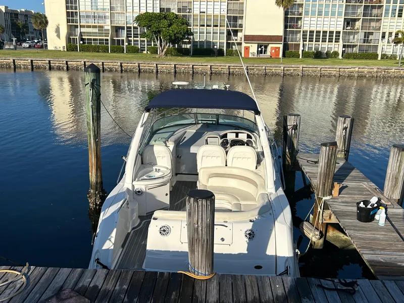Slide: The Image of 2004 Sea Ray 340 Sundancer docked at a marina, viewed from the stern. - 3