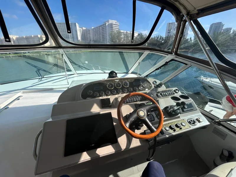 Slide: The Image of 2001 Cruisers Yachts 4450 Express Motoryacht helm with city skyline view. - 38