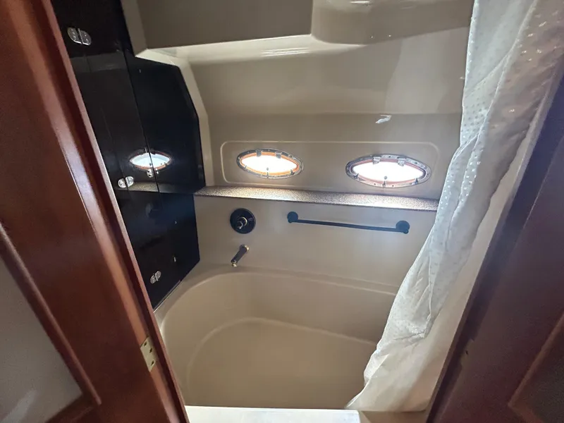 Slide: The Image of Luxurious bathroom in 2001 Cruisers Yachts 4450 Express Motoryacht with porthole windows. - 49
