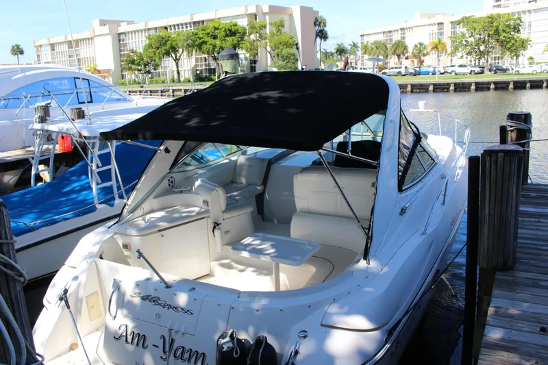 Slide: The Image of 2005 Cruisers Yachts 340 Express docked, rear view with black canopy. - 1