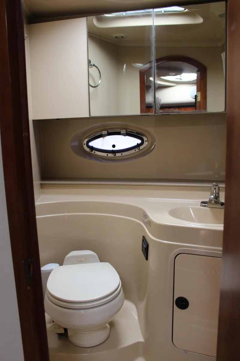 Slide: The Image of 2005 Cruisers Yachts 340 Express bathroom with toilet, sink, and mirror. - 15