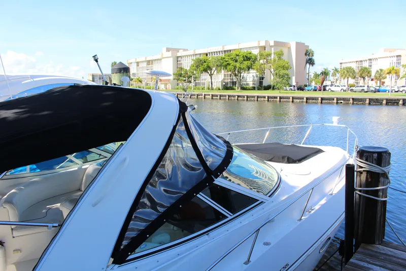 Slide: The Image of 2005 Cruisers Yachts 340 Express docked by waterfront buildings. - 3